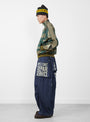 The 11.5oz Denim Jumbo Monkey Pants from Kapital come in indigo at Couverture & The Garbstore
model side 