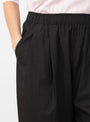 The Spa Pleat Trousers come in Black from Apiece Apart at Couverture & The Garbstore model detail
